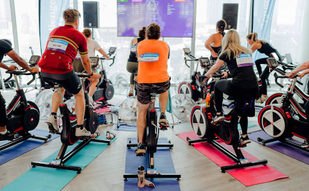 people riding exercise bikes
